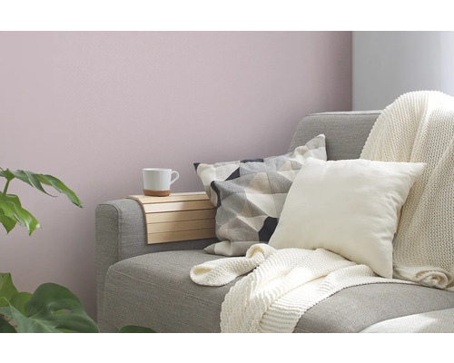 Wohnzimmer mit grauem Sofa, Kissen, Überwurf und Holztisch