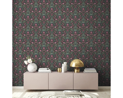 Zimmer mit dunkler floral gemusterter Tapete, Sideboard, Lampe und Dekor