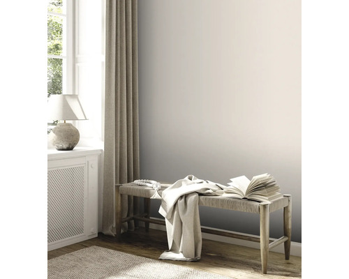 Heller Raum mit Holzbank, Buch und Textilien