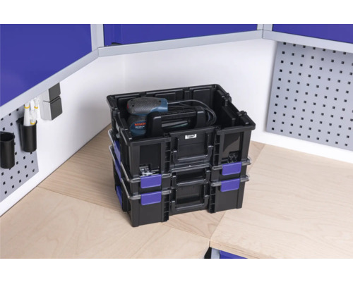 Stapelboxen mit Bohrmaschine im Werkstattbereich