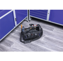 Gefüllte Werkzeugtasche mit verschiedenen Werkzeugen und blauen Werkzeugschränken