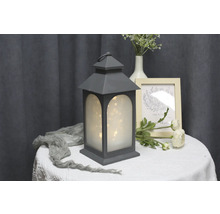 Dekorative Laterne mit Sternenlichtern als Tischdekoration.