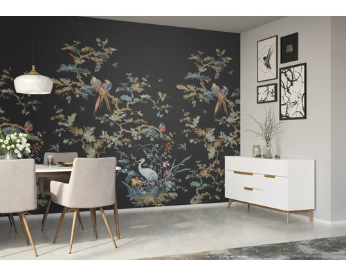 Ein Esszimmer mit Esstisch, Stühlen, Sideboard und einer Wand mit einer Tapete mit Vogel- und Pflanzenmotiven