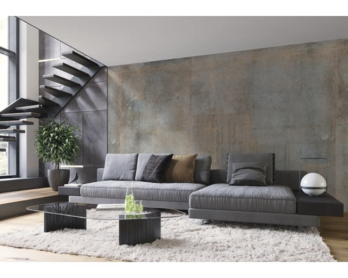 Wohnzimmer mit grauer Couch, gläsernem Couchtisch und Treppe