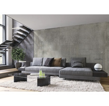 Wohnzimmer mit grauem Sofa, Glastisch und Treppe