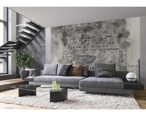 Wohnzimmer mit grauer Couch, Couchtisch aus Glas und Treppe