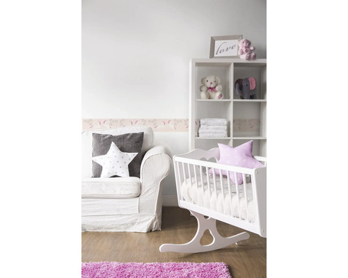 Babyzimmer mit weißem Sofa, Wiege, Regal und rosa Teppich