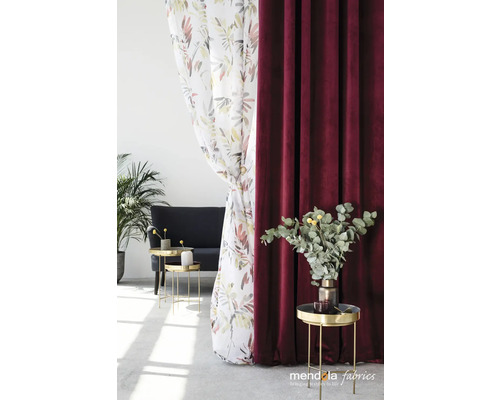 Dekoratives Arrangement mit floralem Vorhang und bordeauxfarbenem Samtvorhang im Wohnraum