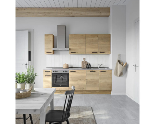 Küchenszene mit Küchenzeile in Holzoptik, Dunstabzugshaube und Essbereich in einem hellen Raum