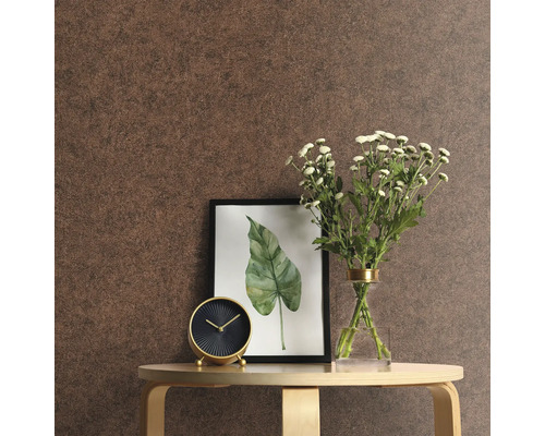 Nahaufnahme eines Raumes mit brauner Tapete, Tisch, Uhr, Blumen und einem gerahmten Bild