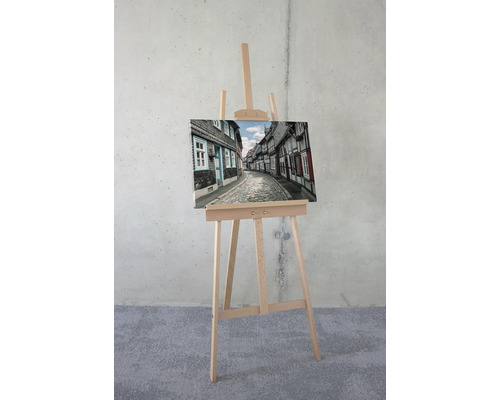 Leinwandbild mit historischer Stadtansicht auf einer Staffelei