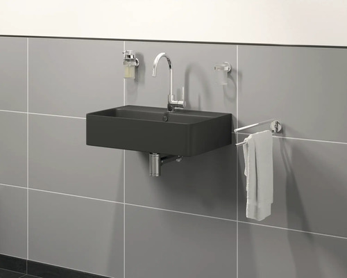 Modernes Badezimmer mit schwarzem Waschbecken, Armatur, Seifenspender, Zahnputzbecher und Handtuchhalter