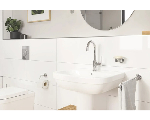 Helles Badezimmer mit Waschbecken, Armatur, Spiegel und Toilette