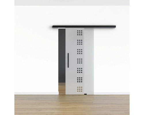 Schiebetür aus Glas mit quadratischen Ausschnitten an einer Wand