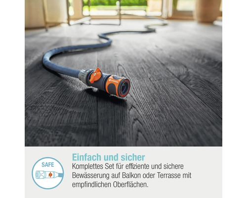 Gardena Schlauch mit Anschlussstück auf Holzboden
