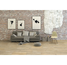 Wohnzimmer mit Sofa, Stuhl und Wanddekoration vor einer Ziegelwand