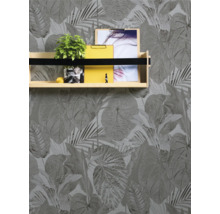 Fotografie einer Wand mit Blättertapete und einem Wandregal mit Dekoration