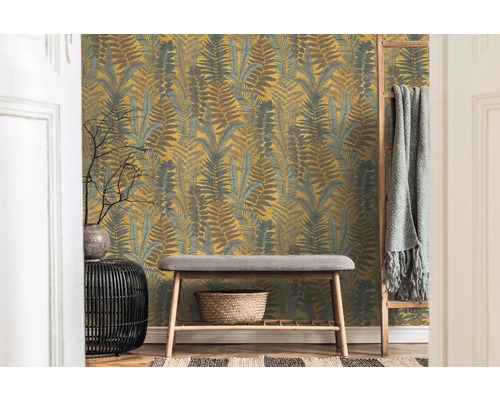 Raum mit Farnmuster-Tapete, Bank und Dekorationen für einen gemütlichen Eindruck.