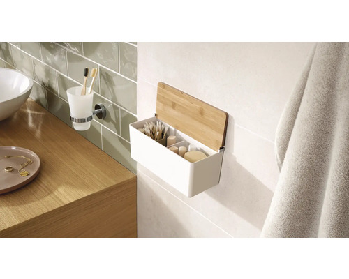 Badezimmer Szene mit einem Waschbecken, einem Zahnputzbecherhalter und einem Wandregal mit Bambusdeckel zur Aufbewahrung von Badezimmerutensilien.