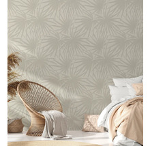 Schlafzimmer mit gemusterter Tapete, Rattansessel und Bett