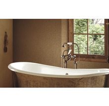 Badezimmer mit Badewanne, Armatur und Fenster mit Holzeinfassung
