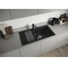 Spüle aus Verbundmaterial mit Abtropffläche und Wasserhahn in einer modernen Küche