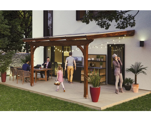 Überdachte Terrasse mit Gartenmöbeln, Grill und Pflanzgefäßen an einem Wohnhaus