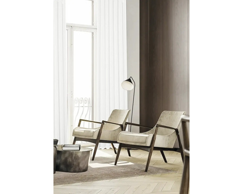 Wohnzimmer mit zwei Sesseln, Stehlampe und Beistelltisch auf einem Teppich