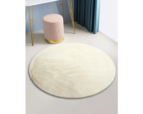 Runder Teppich im Raum mit Hocker und Tisch