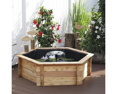 Gartenteich mit Holzumrandung, Springbrunnen und Seerosen auf einer Terrasse