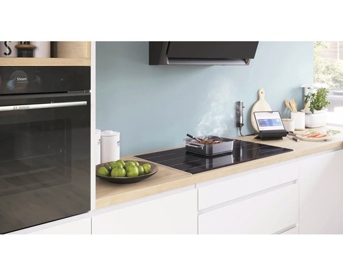 Helle Küche mit Elektroherd, Dunstabzugshaube und Bosch Backofen.