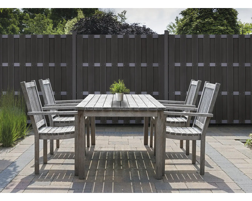 Gartenszene mit Holztisch, Stühlen und Zaun