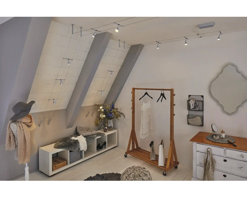 Attic room with track lighting system, clothes rack, dresser, and mannequin