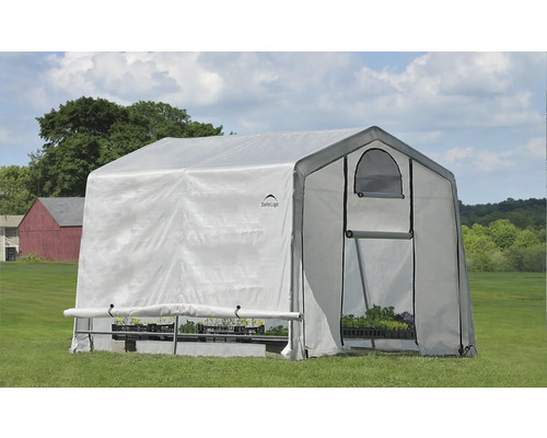 Gewächshaus mit Pflanzen auf einer Wiese