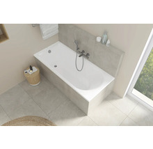 Helle Badezimmeransicht mit weißer Badewanne, Armatur und Ablagefläche