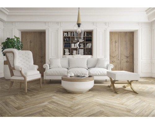 Helles Wohnzimmer mit Sofa, Sessel und Bücherregal