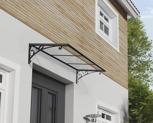 Vordach mit filigranem Stahlrahmen und transparenter Bedachung über einer Haustür.