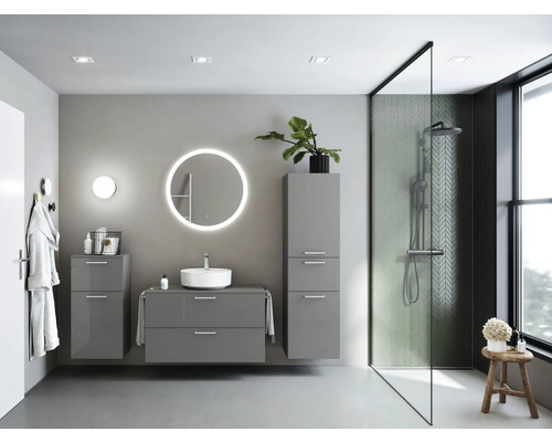 Modernes Badezimmer mit grauen Badmöbeln, runden Spiegel und begehbarer Dusche.