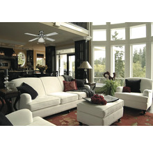 Heller Wohnraum mit Deckenventilator, Sofa und Sesseln
