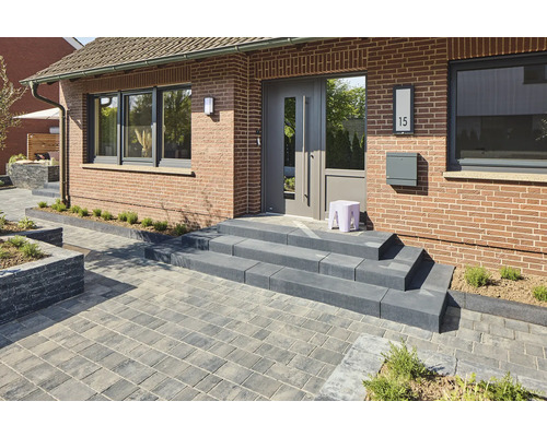 Außenaufnahme eines Hauses mit Pflastersteinen, Treppe und Haustür