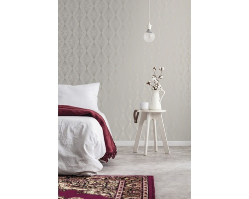 Schlafzimmer mit gemusterter Tapete, Bett, Beistelltisch und Teppich