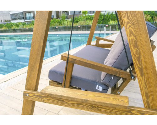 Hängeliege aus Holz mit grauen Polstern am Pool
