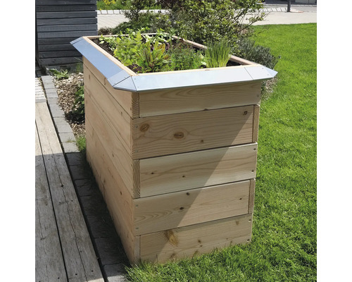 Hochbeet aus Holz mit Pflanzen auf Rasen