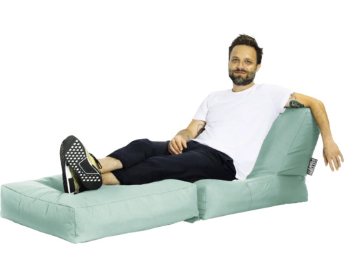 Mann entspannt auf einem mintfarbenen Sitzsack Sofa