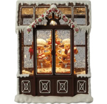 Dekoratives Lebkuchenhaus mit Lebkuchenmännern und Schnee als Weihnachtsdekoration