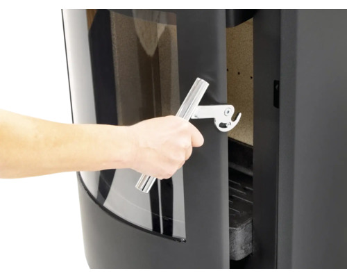 Detailansicht eines Kaminofens beim Öffnen der Tür mit einem Griff.