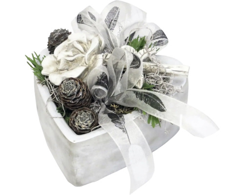 Dekoratives Blumenarrangement mit Schleife im Topf