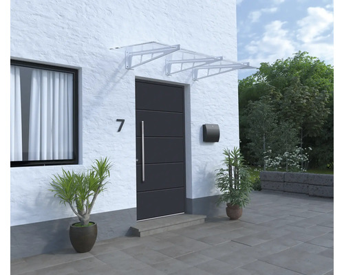 Haustür mit Vordach, Briefkasten und Pflanzen in Töpfen vor einem Haus.