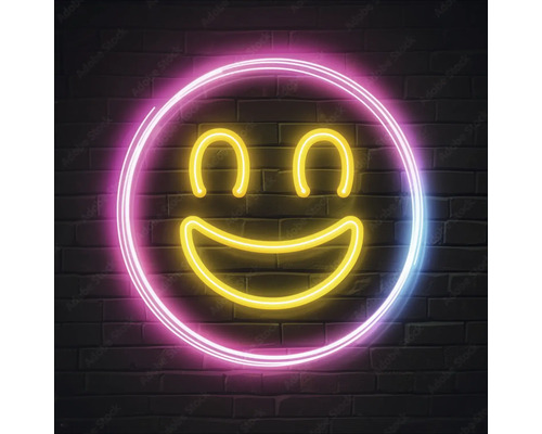 Neonleuchte mit Smiley Gesicht vor einer Ziegelwand
