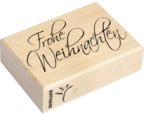 Holzstempel mit der Aufschrift Frohe Weihnachten